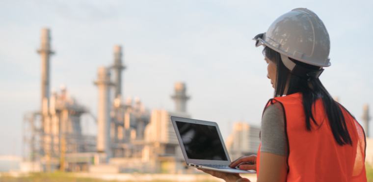 female_engineer_wearing_hard_hat_with_laptop_at_power_plant